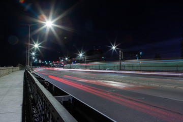 Car trails at night on the road towards Sydney Harbour Bridge.