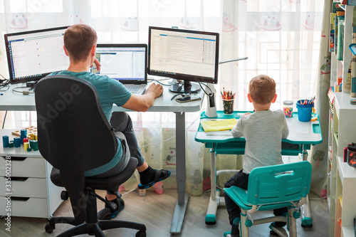 Fotografía Father with kid working from home during quarantine