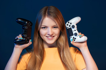 Wall Mural - Girl holding two joysticks like pistols ready to start challenge