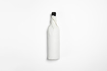 Bottle Of Red Wine Mock-up Wrapped In Craft Paper On White Background.High Resolution Photo.