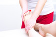 © Elena - Foot massage in spa salon, closeup. foot massage relax skin care. Therapeutic pedicure.
