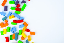 Different Colored Building Blocks Scattered Across A White Isolated Background