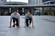 © tharathip - Young couples pose happily in exercise clothes while exercising.