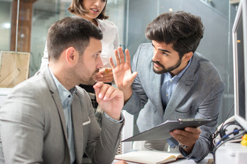 Wall Mural - Business people looking at each other and arguing about document at workplace