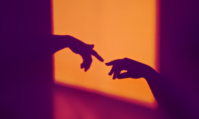 Abstract shadow silhouette of gesture touch by humans palms in contrasting colors