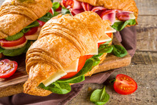 Homemade Croissant Sandwiches With Ham, Cheese, Fresh Vegetables And Herbs,