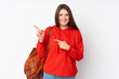 © luismolinero - Teenager caucasian student girl isolated on white background pointing finger to the side