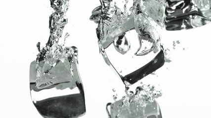 Poster - Super slow motion of falling ice cubes into water on white background. Filmed on very high speed camera, 1000 fps.