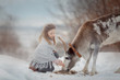 Little girl portrait with white deer in winter forest