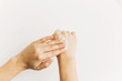 Hand applying moisturizing cream on skin after washing hands and using alcohol gel during virus epidemic. Treatment for dry skin. Luxury skin care. Hand cream. Avoiding dry skin