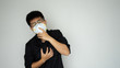 © khotchaporn - The man wearing face hygienic mask, N95 mask for prevention global covid-19 virus pandemic. He chest pain hand protect close mouse from infectious coronavirus china virus, wuhan