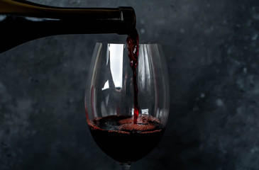 pour wine on a stone background