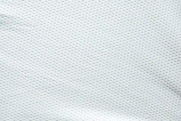 Selective focus, White mesh fabric background. cloth sport wear texture for exercise. light weight, good air flow, cool and easy to dry from sweat. abstract wallpaper with copy space for text.