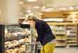 © lado2016 - Teenager shopping in supermarket, reading product information