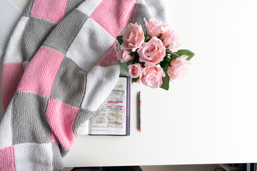 Wall Mural - Pink Bible flat lay: Bouquet of pink roses, open Bible, black tea, coffee, journal, notebook, pen and pink blankets. Morning devotional. Rose, white, grey tones. Baselland, Switzerland - 02.04.2020