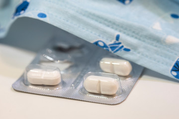 Face mask and many tablets close-up . COVID-19.