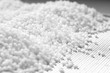 Closeup of a granule of white plastic polymer