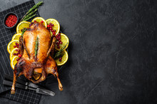 Baked Duck Stuffed With Oranges And Rosmarina. Festive Table. Black Background. Top View. Space For Text