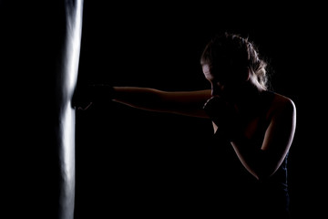 Wall Mural - kick fighter girl punching a boxing bag