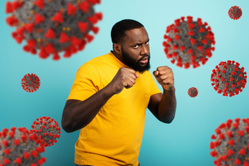 Man attacks with a punch the covid19 coronavirus. Blue background