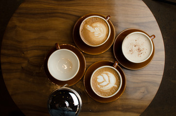 4 hot cups of coffee  on wooden table