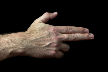 male palm with several bent fingers is shaped like a gun. concept of legalization of firearms.