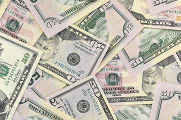 Wall Mural - Many US fifty dollar bills on flat background surface close up. Flat lay top view. Abstract business concept