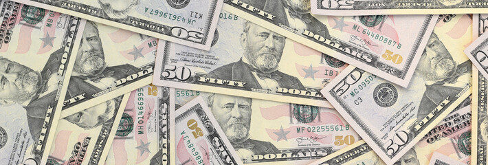 Wall Mural - Many US fifty dollar bills on flat background surface close up. Flat lay top view. Abstract business concept