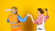 © be free - Decorating apartment. Pick color. DIY repair. Construction workers. Woman builder. Man painter or decorator. Interior renovation. Home renovation. Painting walls. Cheerful couple renovating house