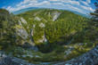 Overview of Skocjan caves way below the village of Skocjan on a picturesque summer day. Fish eye or wide angle view of Skocjan caves.