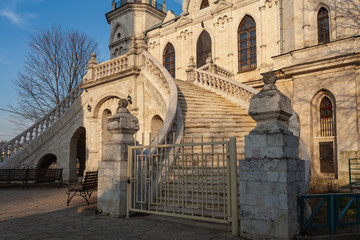 Wall Mural - Fragment of the facade of an old Orthodox church with a picturesque arched staircase