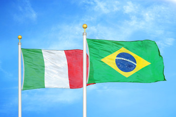 Italy and Brazil  two flags on flagpoles and blue cloudy sky