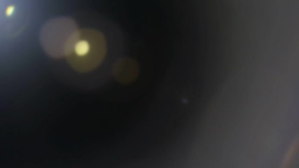 Wall Mural - beautiful abstract defocused lens flare on a dark background. real light leaks and lens flare.