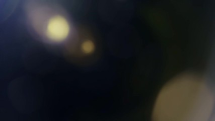 Wall Mural - beautiful abstract defocused lens flare on a dark background. real light leaks and lens flare.