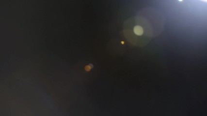 Wall Mural - beautiful abstract defocused lens flare on a dark background. real light leaks and lens flare.