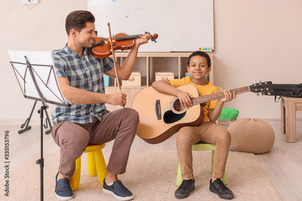 Teacher giving music lessons at school