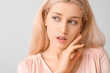 Canvas Print - Young woman with beautiful makeup on light background