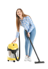 Poster - Young woman with vacuum cleaner on white background