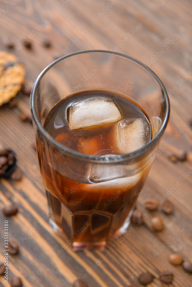 Glass of tasty iced coffee on table