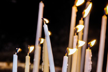 Long Thin Burning Candles In A Church Close Up