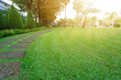 © Arunee - Pattern of Laterite steping stone on a green Lawn in the public park, Ficus and shurb on the left , Trees in background under evening sunlight