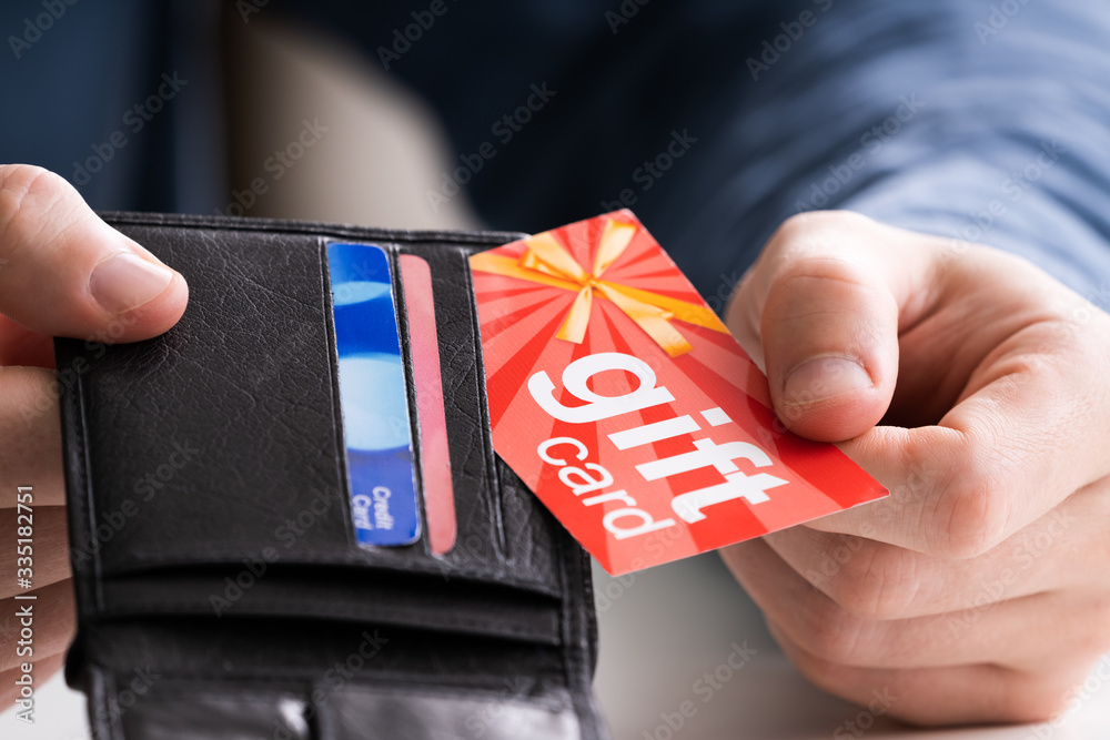 Human Hand Removing Gift Card From Wallet - obrazy, fototapety, plakaty 