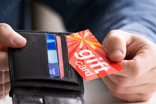 Fotomural Human Hand Removing Gift Card From Wallet