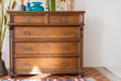 old antique old mahogany chest of drawers in a room with additional decor. interesting design