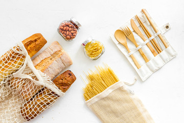 Wall Mural - Glass jars, cotton bags on white background, top view. Eco friendly concept for kitchen - food storage