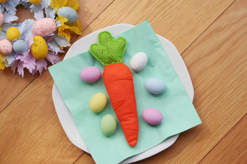 Wall Mural - Carrot made by felt with Easter decorations on wooden table. Easter background
