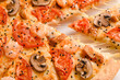 macro view of pizza with shrimp and mushroom and slice with stretching cheese.