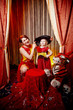 © keleny - Family during a stylized theatrical circus photo shoot in a beautiful red location. Models mother and daughter posing on stage with curtain