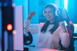 © Artem - The beautiful gamer girl with headphones playing video games