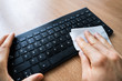 © Andrey Popov - Man Wiping Keyboard With Sanitizer